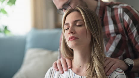 Woman receiving a shoulder massage from her partner