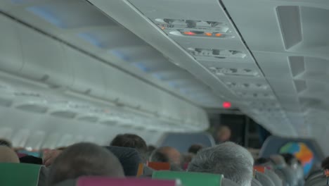 passengers on an airplane in the middle of the flight with little turbulences