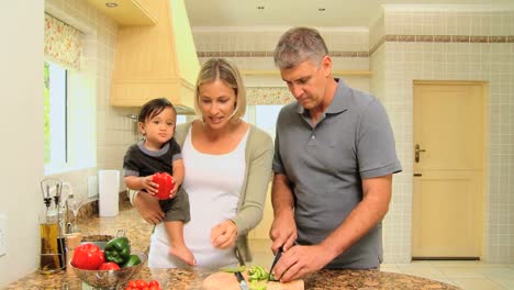 baby with parents tasting vegetables