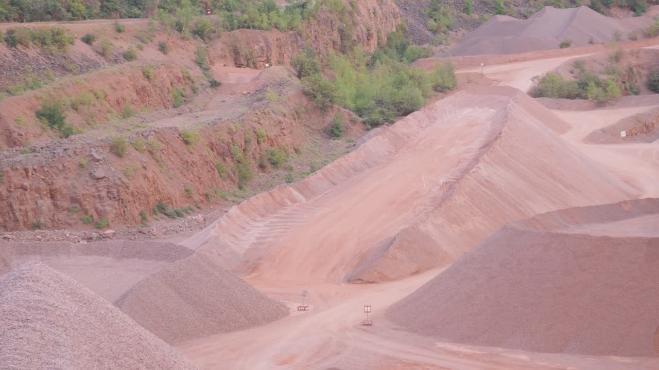 Pan Across Empty Quarry Used for Excavating Raw Materials Like Sand Stone Gravel for Use in Construction Industry for Buildings and Roads