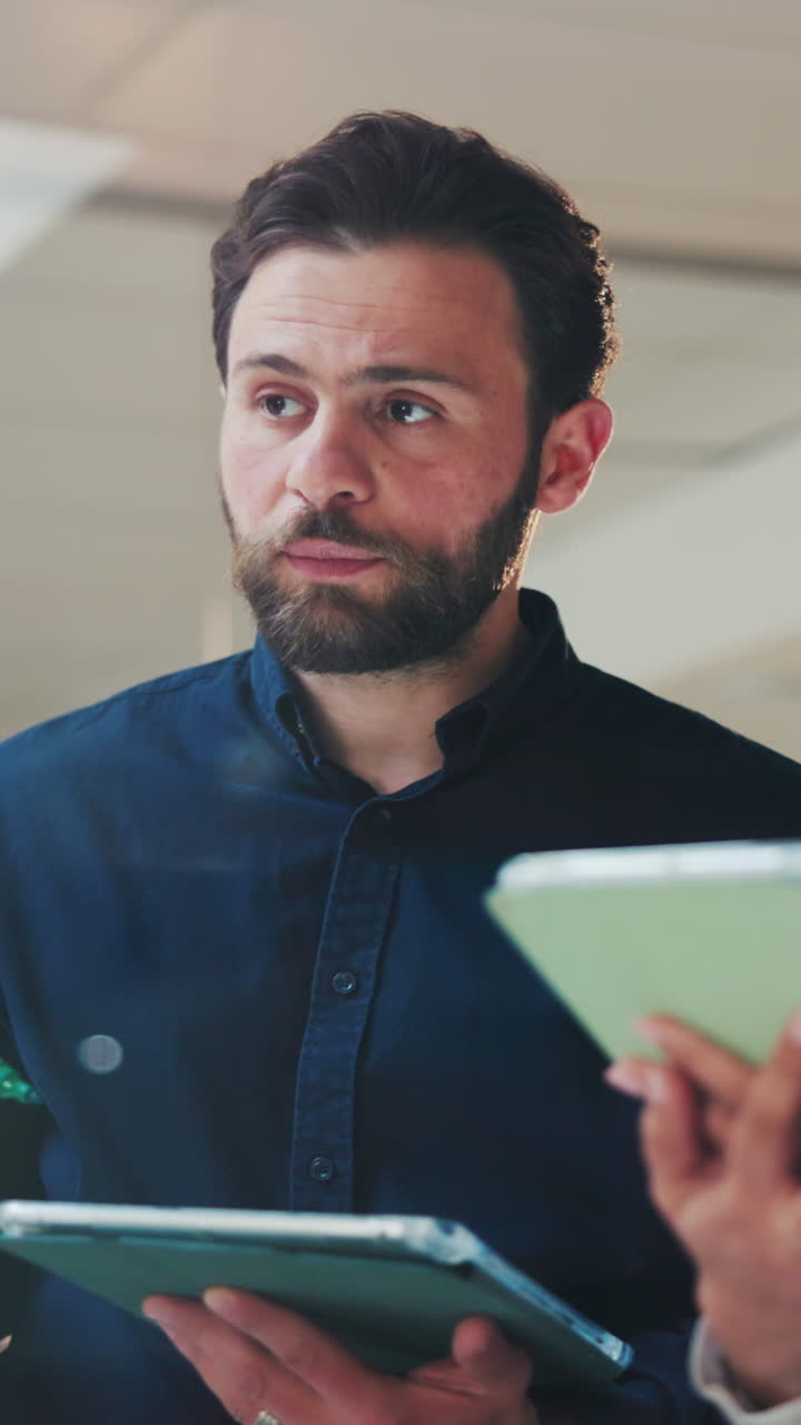 Bearded Businessman Discussing Ideas with Colleague in Office