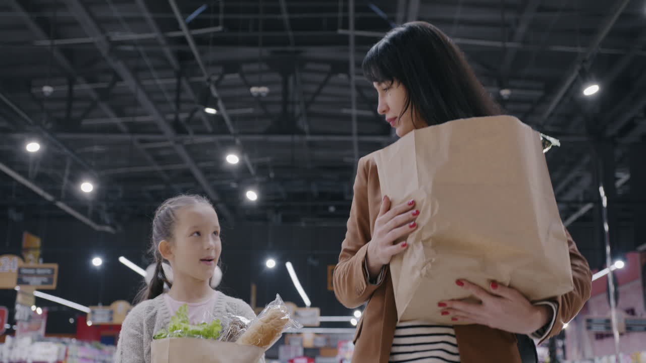Mother and Daughter Shopping at Grocery Store