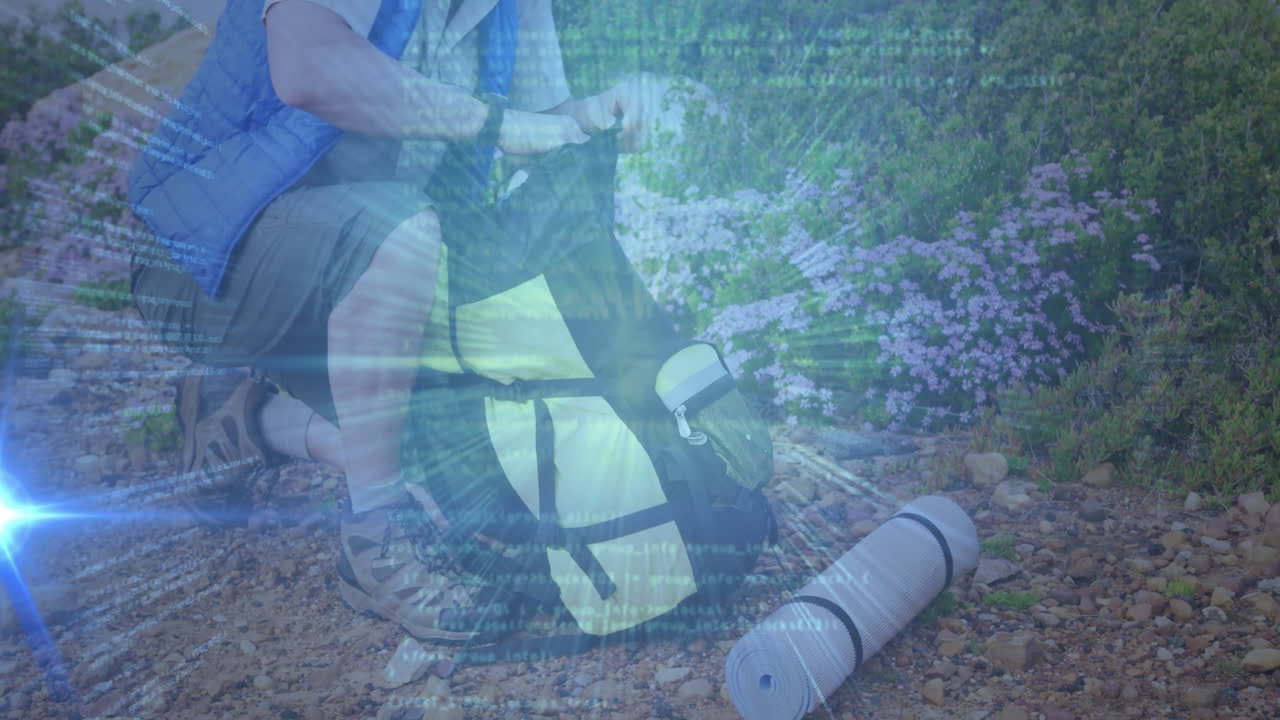 Man kneeling on rocky trail, adjusting hiking backpack, displaying outdoor gear marketing icons