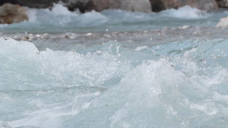 Detail-shot-in-slowmotion-of-how-the-water-falls-in-the-Venosc-river-showing-the-textures-of-the-water,-French-Alps
