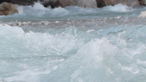 detail shot in slowmotion of how the water falls in the venosc river showing the textures of the water, french alps