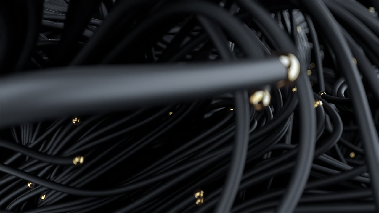 Black plastic cables with golden tips in abstract motion