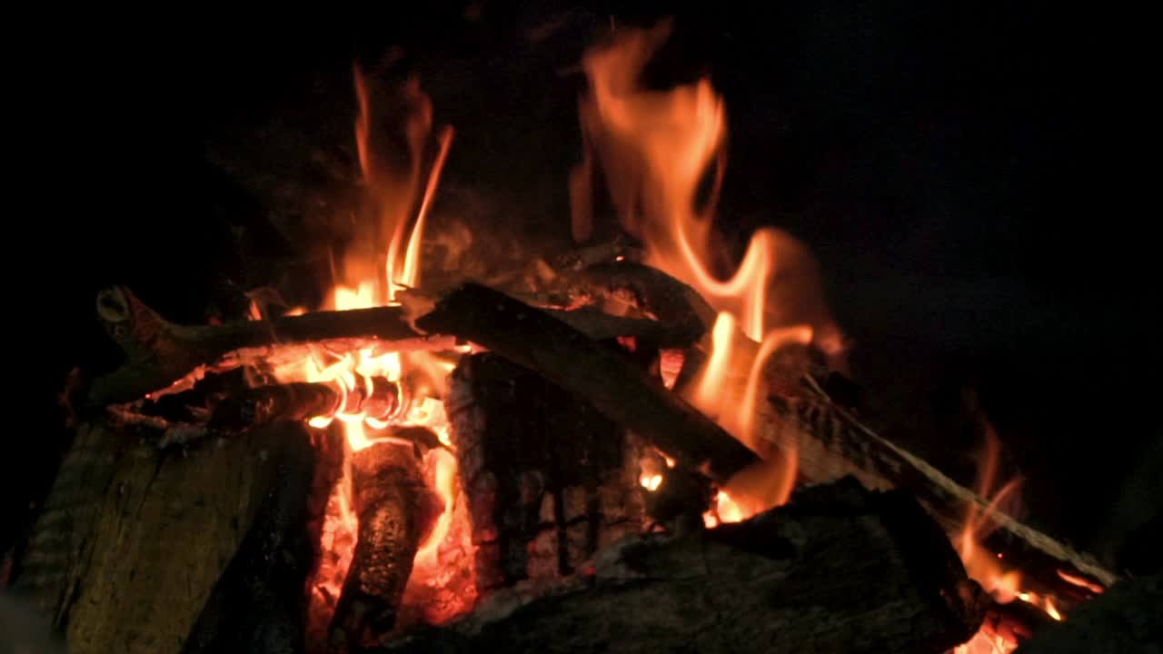 Warm Campfire With Burning Wood, Hot Smoke And Blazing Red Orange Fiery Flames Embers - close up