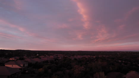 aerial shot over an american suburb at sunset, dolly forward