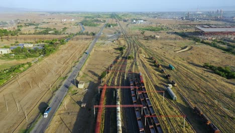 following shot of a train moving on railway in rural area in georgia on a sunny day