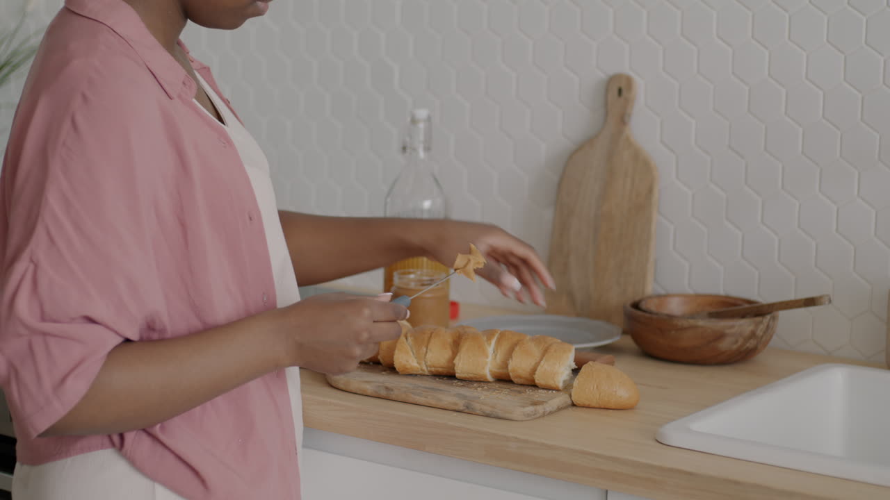 Woman preparing a peanut butter and bread breakfast