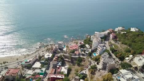 Aerial-drone-shot-above-mexican-resort-town-along-the-Pacific-shoreline-in-the-state-of-Sinaloa,-Mexico-with-sea-ocean-view
