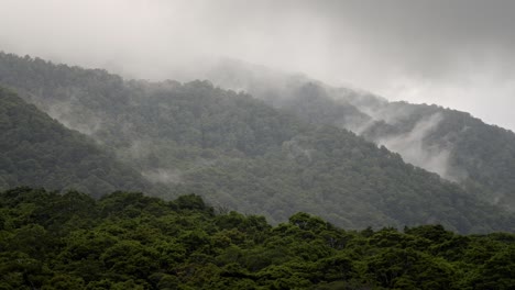 misty mountains above a beautiful majestic valley with clouds forming