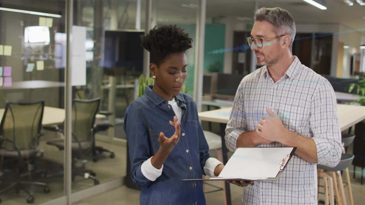 Man leaning in speaking, woman holding clipboard, blue overlays marking lines for project review