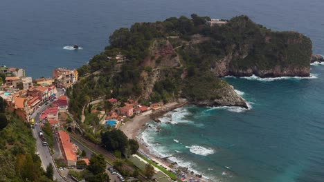 wide shot of taormina beach, oceanfront streets, and homes by the sea in sicily, italy (italia)