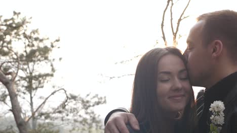 romantic couple embracing and kissing in a spring park
