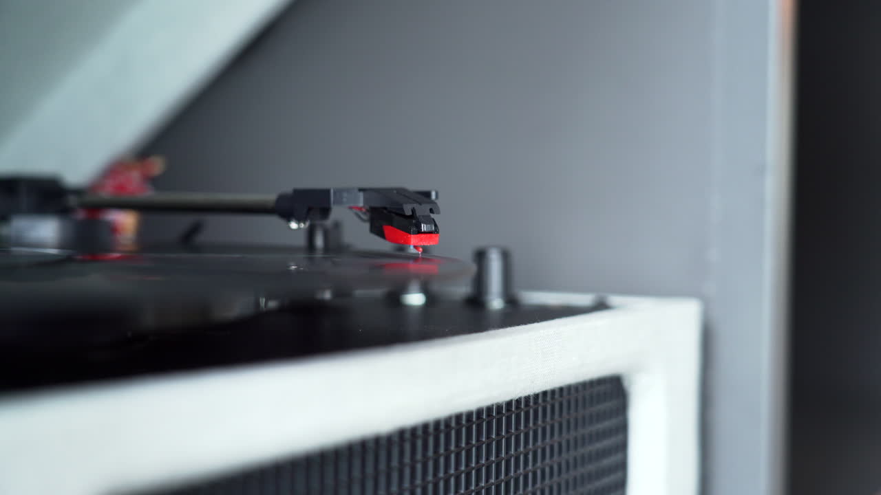 Moving the head of a record player to start playing an old vinyl