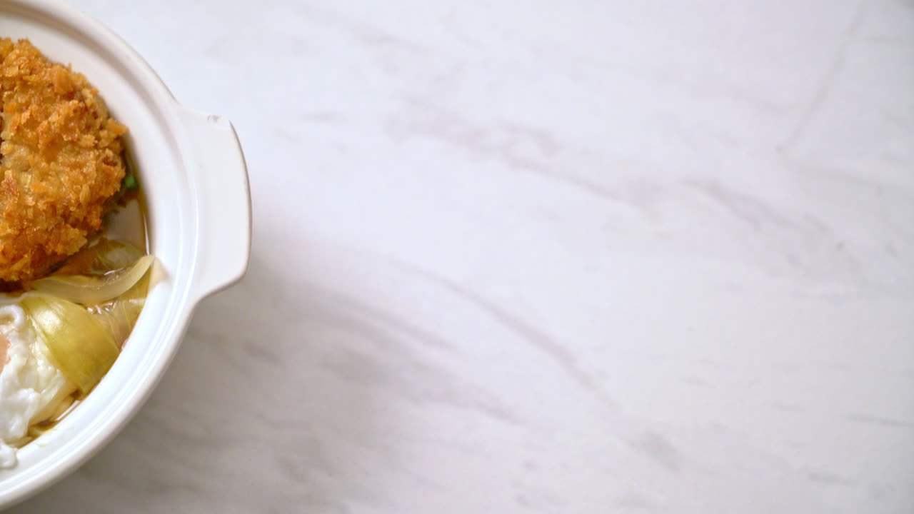 Japanese fried pork cutlet (katsudon) with onion soup and egg - Asian food style