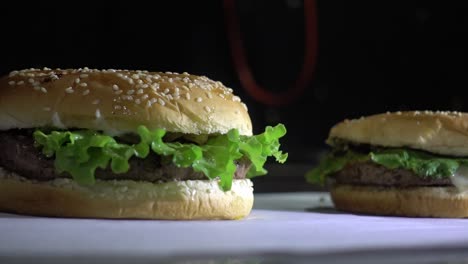 slow dolly right revealing multiple burgers served on paper ready for serving