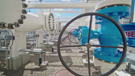 close-up of a valve wheel at a natural gas pumping station, sunny day