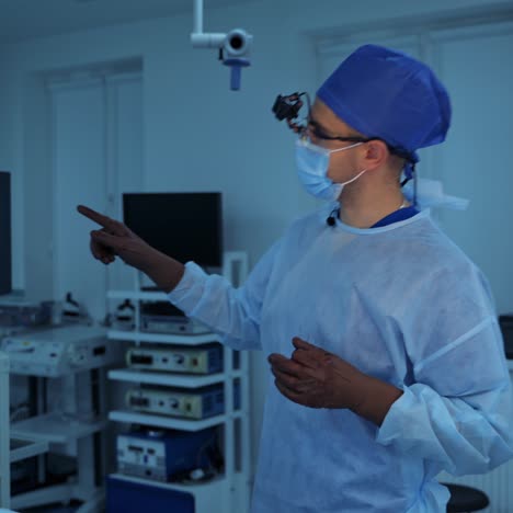 neurosurgeon explains methods of future operation. modern operation room with futuristic equipment. doctor in scrubs