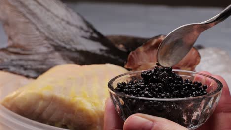 preparing a dish with caviar and fish