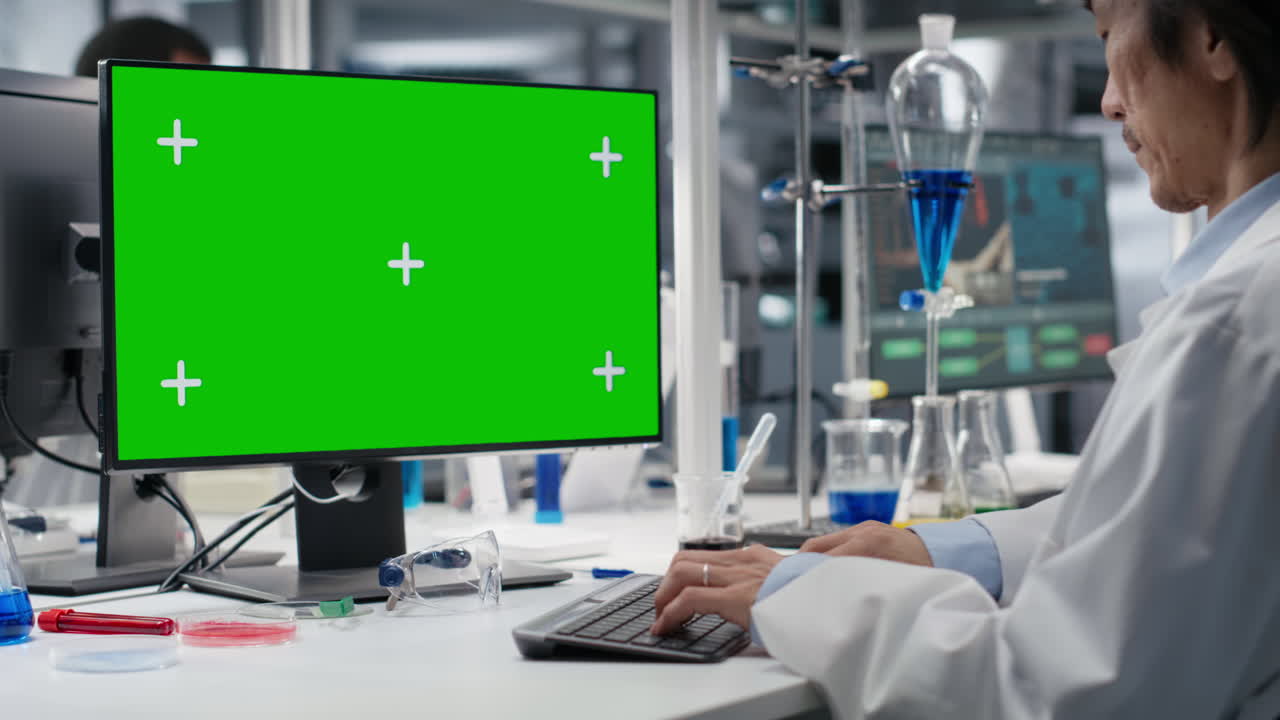 Lab Technician Using Green Screen Computer For Dna Data Analysis