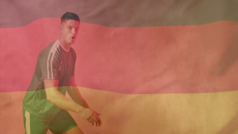 Animation-Der-Flagge-Deutschlands-über-Einem-Kaukasischen-Männlichen-Footballspieler,-Der-Einen-Ball-Tritt