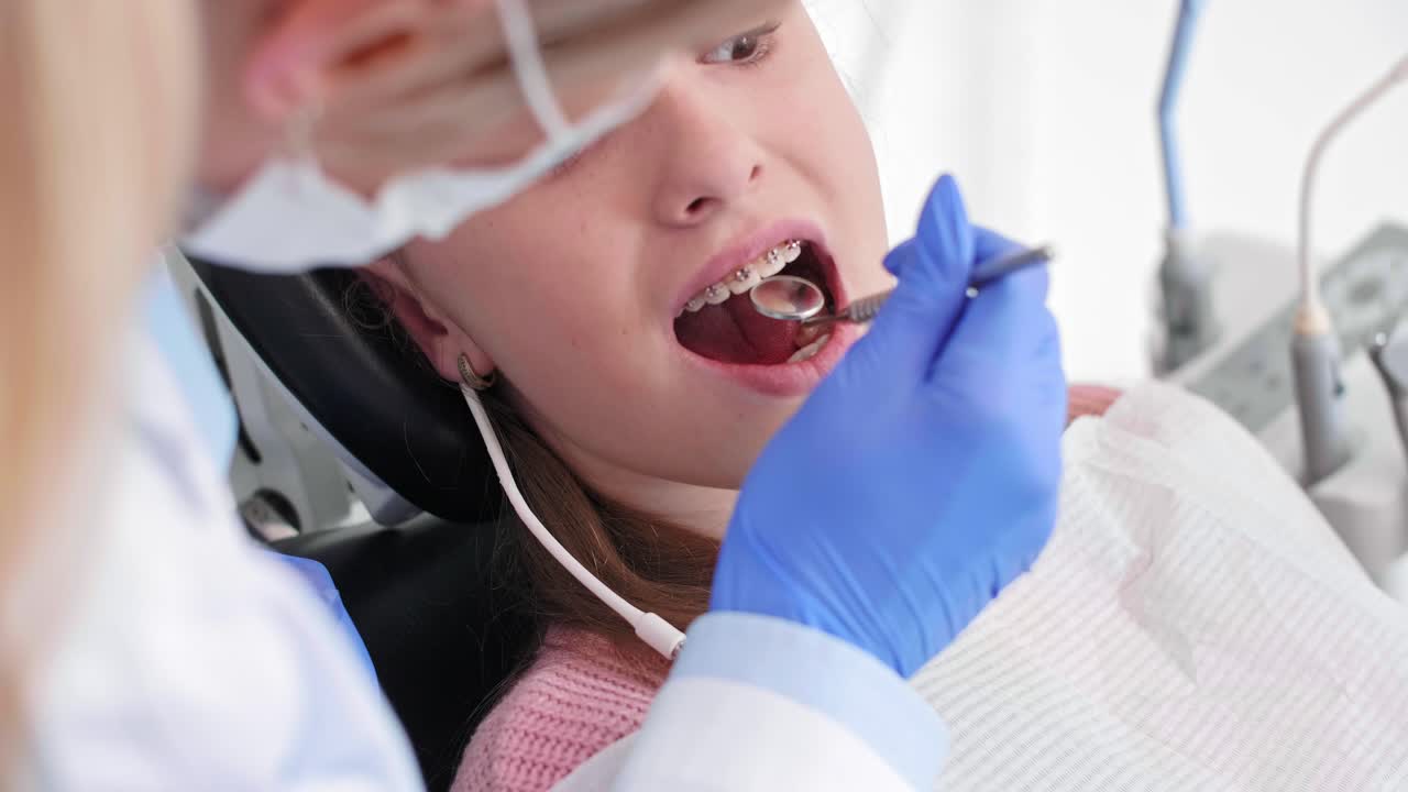 Part of dentist using dental mirror during check up