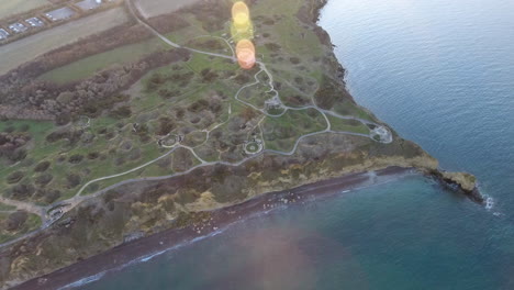 drone sunset flare over la pointe du hoc casemates and shell holes after ww2