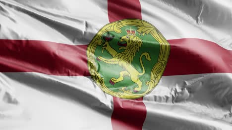 la bandera de alderney se agita lentamente en el bucle del viento. el estandarte de alderney se balancea suavemente en la brisa. fondo de relleno completo. bucle de 20 segundos.
