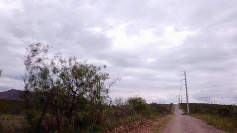 Power-lines-on-a-dirt-road-in-an-American-desert