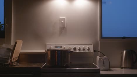 big pot with boiling content on old stove top
