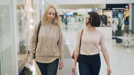 two women shopping in a mall