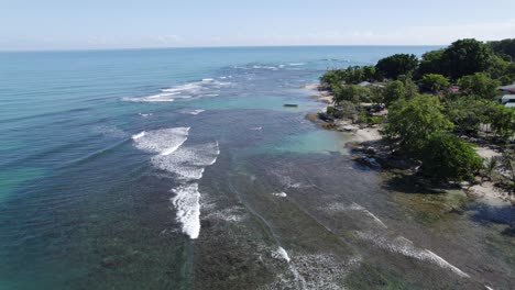 tropical beach aerial view with turquoise water and fishing boat