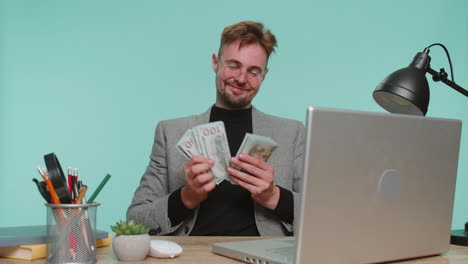 rich happy business man satisfied of income earnings counting money dollar cash dancing celebrate