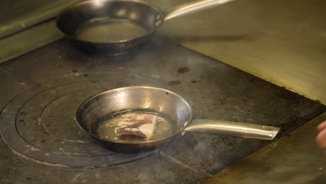 a chef is cooking food in the small pan
