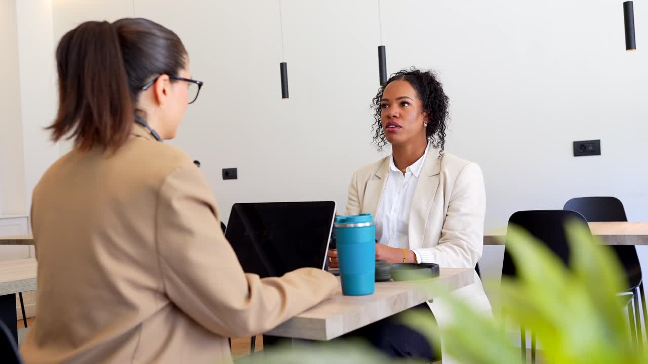 Two women in a job interview or business meeting at the office
