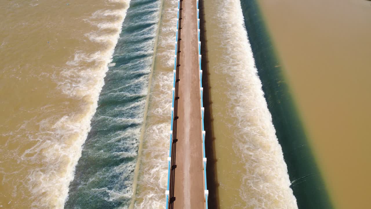 Polluted water dumping in river, chemical waste fast fashion industry Cambodia, aerial drone