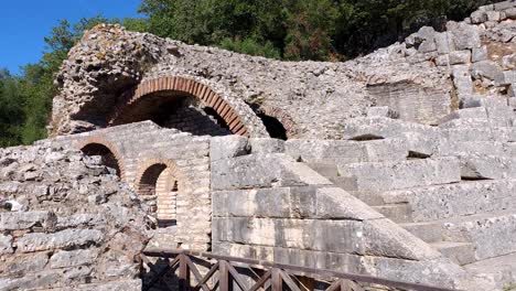 butrint's ancient city, arched beauty of amphitheater stone walls, tourists summer vacation in albania