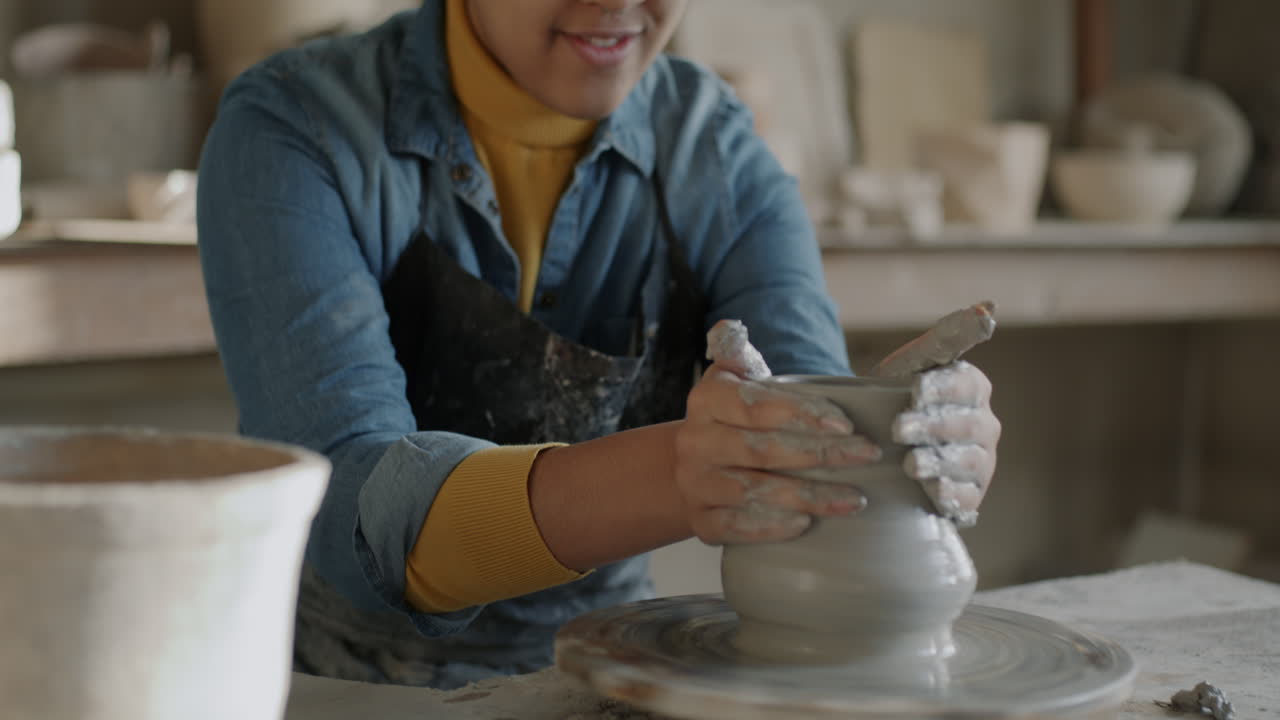Young woman working on pottery wheel