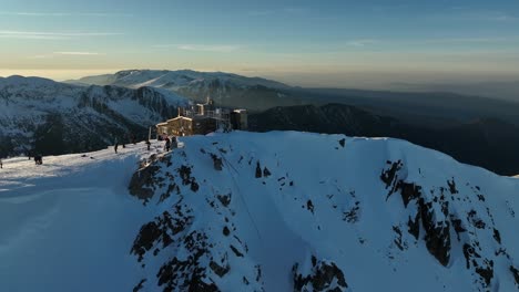 Drone-shot-around-Musala-peak,-summit-during-sunset,-dusk,-Bulgaria,-Rila-mountain,-highest-summit-on-the-Balkans,-clear-sky,-amazing,-stunning-view,-twilight,-blue-hour,-golden-hour
