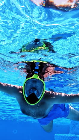 man snorkeling in a swimming pool
