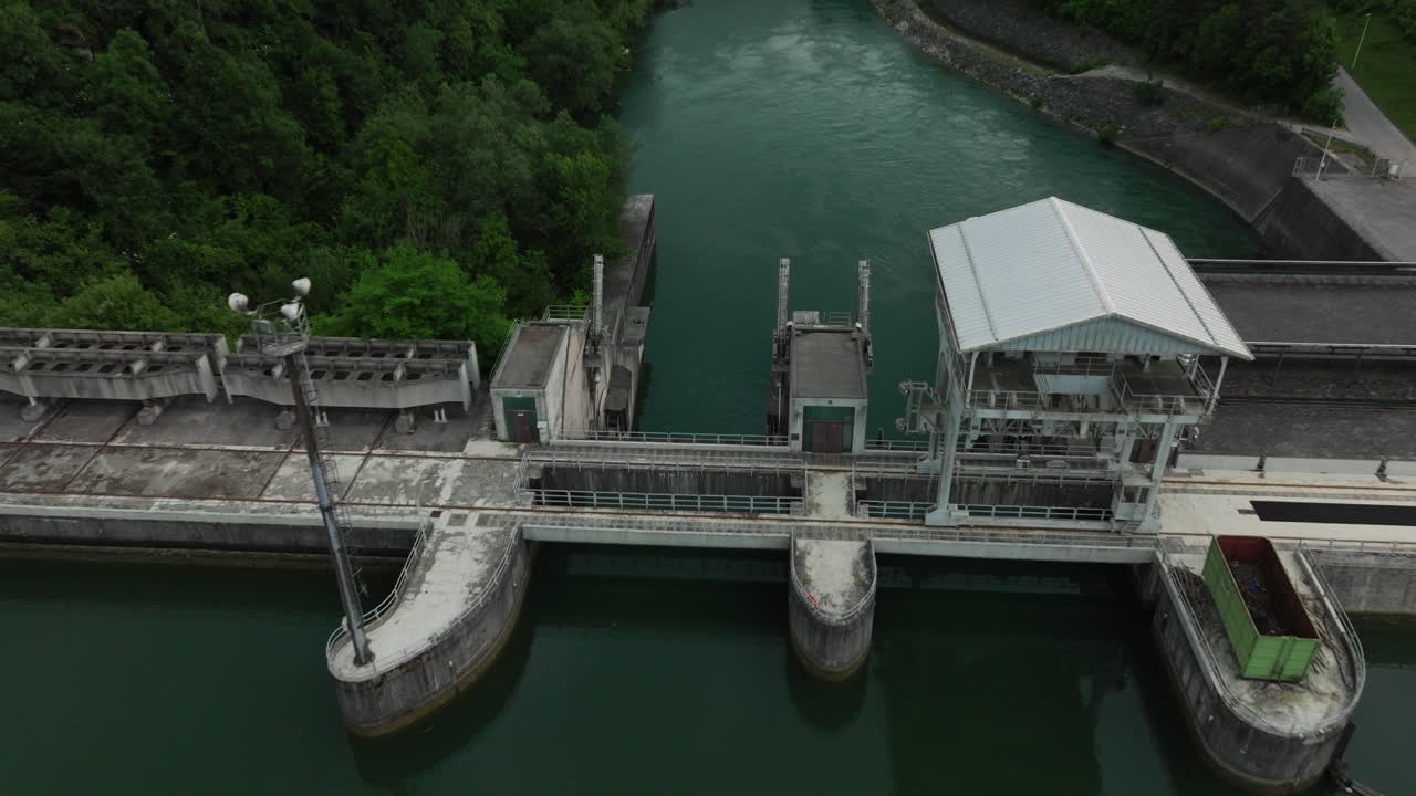 Hydroelectric power station Mavčiče located on the Sava River in Slovenia, producing renewable energy surrounded by nature and flowing water in a calm, industrial landscape.