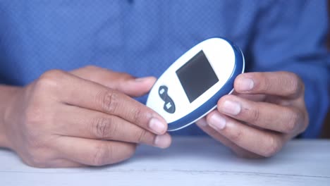 person holding a blood glucose meter