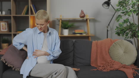 pregnant woman experiencing back pain while using phone