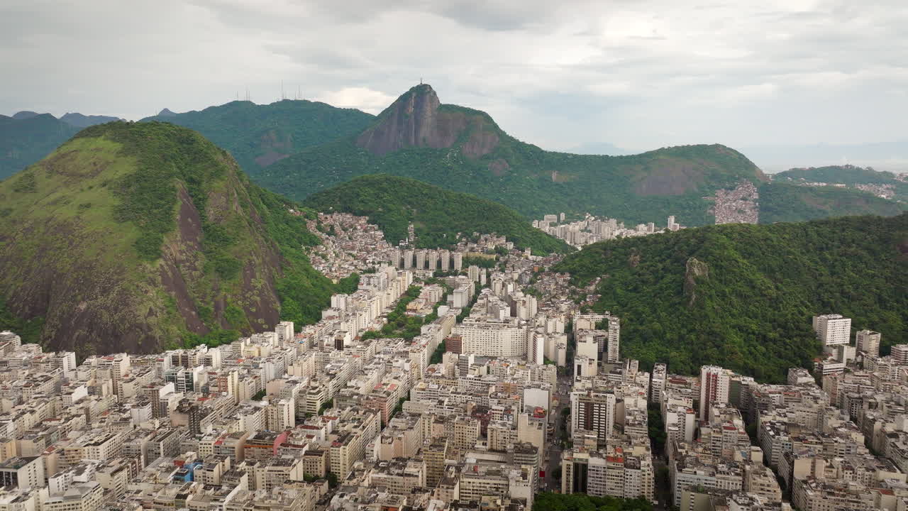 High panoramic drone view of underprivileged favelas on Rio de Janeiro hillsides