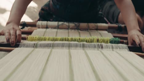 Mayan-Weaver-Working-On-A-Traditional-Handloom-In-Antigua,-Guatemala,Central-America---high-angle-shot