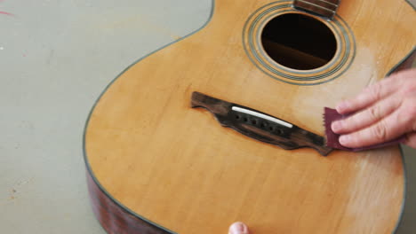 wood sanding a destroyed part of a guitar in hopes to restore it