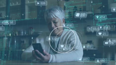animation of social media icons and data processing over senior woman using smartphone
