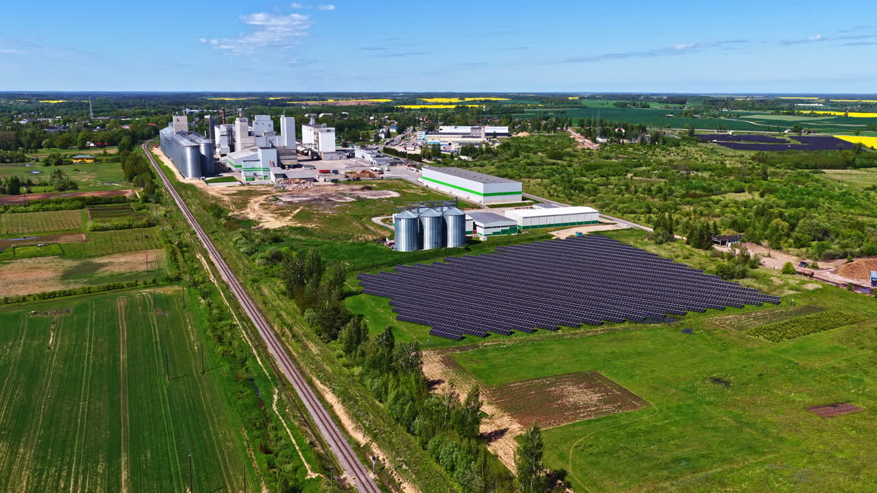 Farming building complex and solar panel field, aerial view